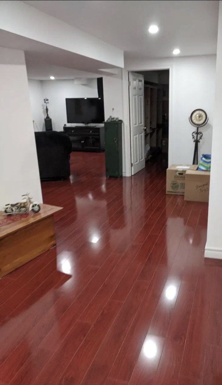 Oshawa basement with new high-gloss laminate flooring